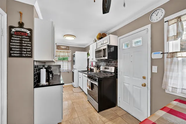 a kitchen with stainless steel appliances granite countertop a refrigerator and a stove top oven