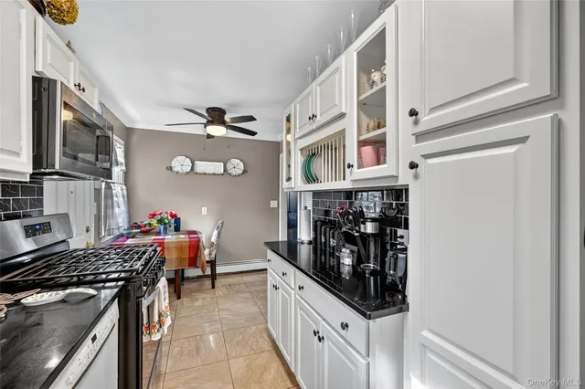 a kitchen with stainless steel appliances granite countertop a stove and a refrigerator