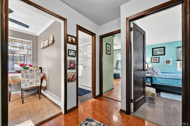 a living room with furniture and paintings on the wall