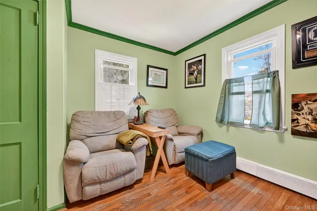 a living room with furniture a couch and painting on the wall