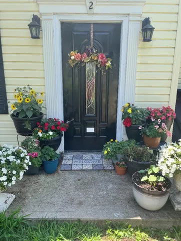 a view of a house with a yard and garden