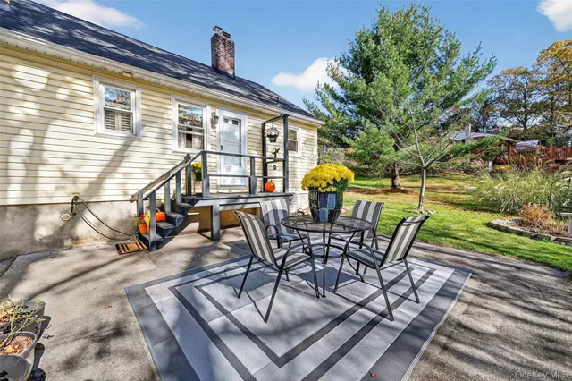 a view of a patio with table and chairs and potted plants