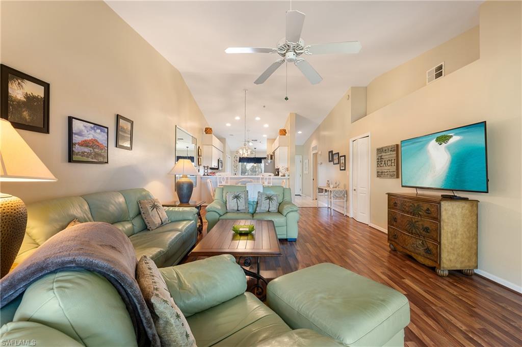 26991 Clarkston Drive, Unit 8202 Bonita Springs, FL 34135 - Photo 11 of 20 a living room with furniture and a flat screen tv