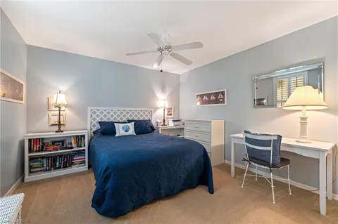 a bedroom with a bed chair and window