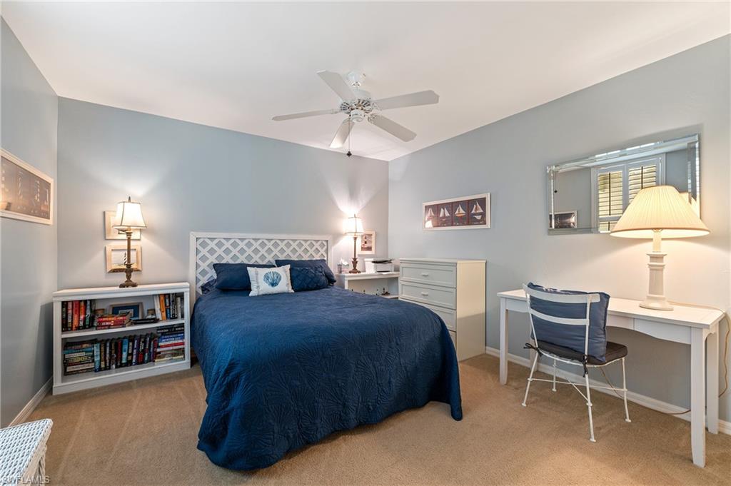 26991 Clarkston Drive, Unit 8202 Bonita Springs, FL 34135 - Photo 14 of 20 a bedroom with a bed and a chandelier