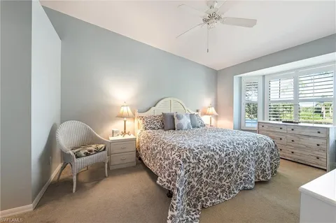 a bedroom with a large bed and a flat screen tv