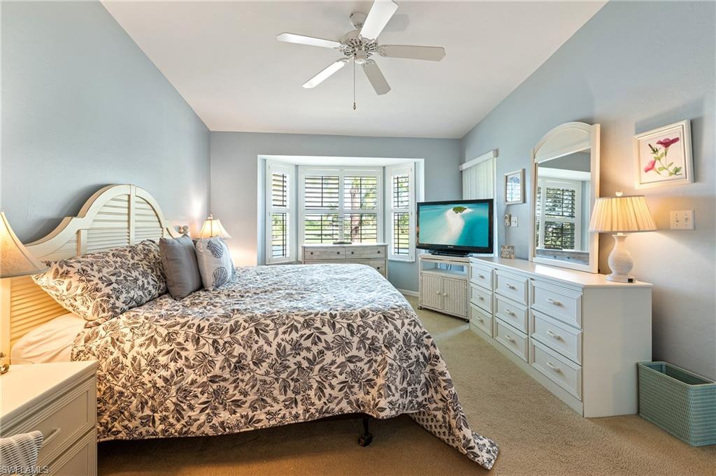 26991 Clarkston Drive, Unit 8202 Bonita Springs, FL 34135 - Photo 16 of 20 a bedroom with a large bed and a flat screen tv