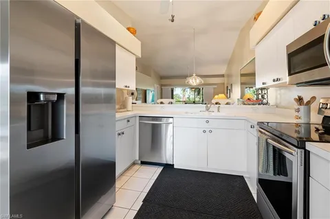 a kitchen with a sink stove and microwave