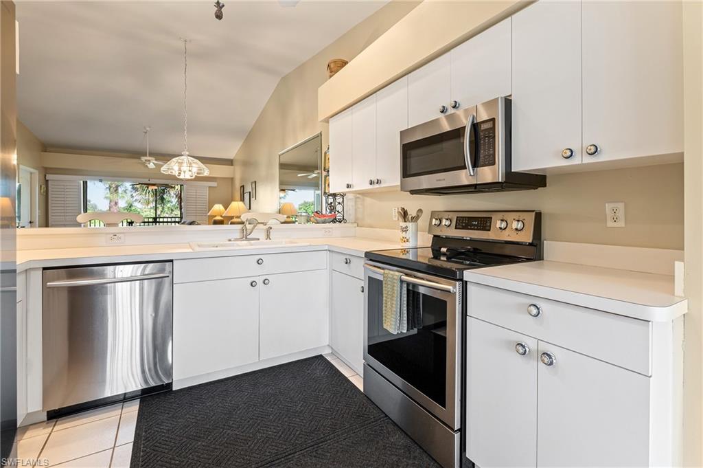 26991 Clarkston Drive, Unit 8202 Bonita Springs, FL 34135 - Photo 5 of 20 a kitchen with a sink stove and microwave