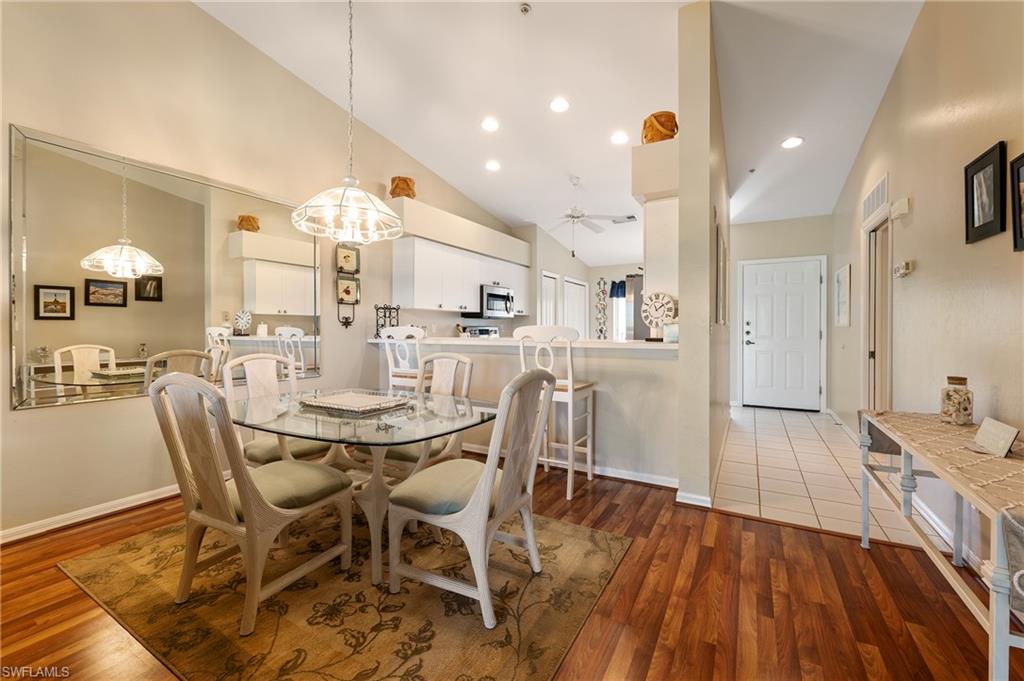 26991 Clarkston Drive, Unit 8202 Bonita Springs, FL 34135 - Photo 6 of 20 a view of a dining room with furniture and wooden floor