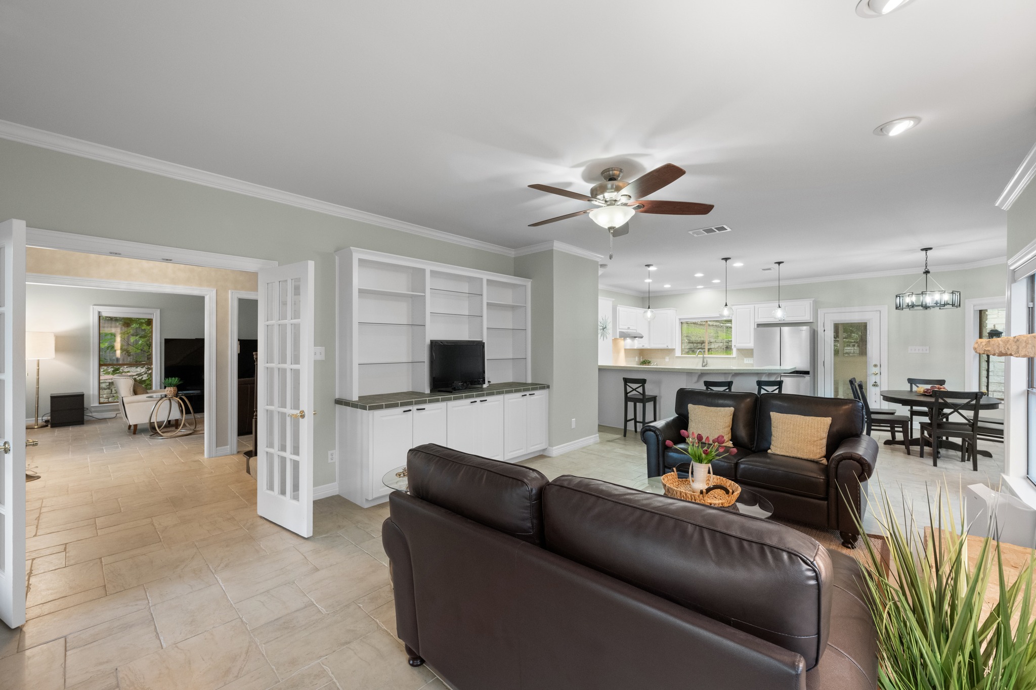 6004 Mt Bonnell Road Austin, TX 78731 - Photo 10 of 24 a living room with furniture and a flat screen tv with kitchen view