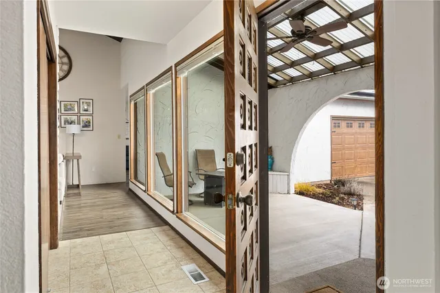 a living room with furniture and large windows