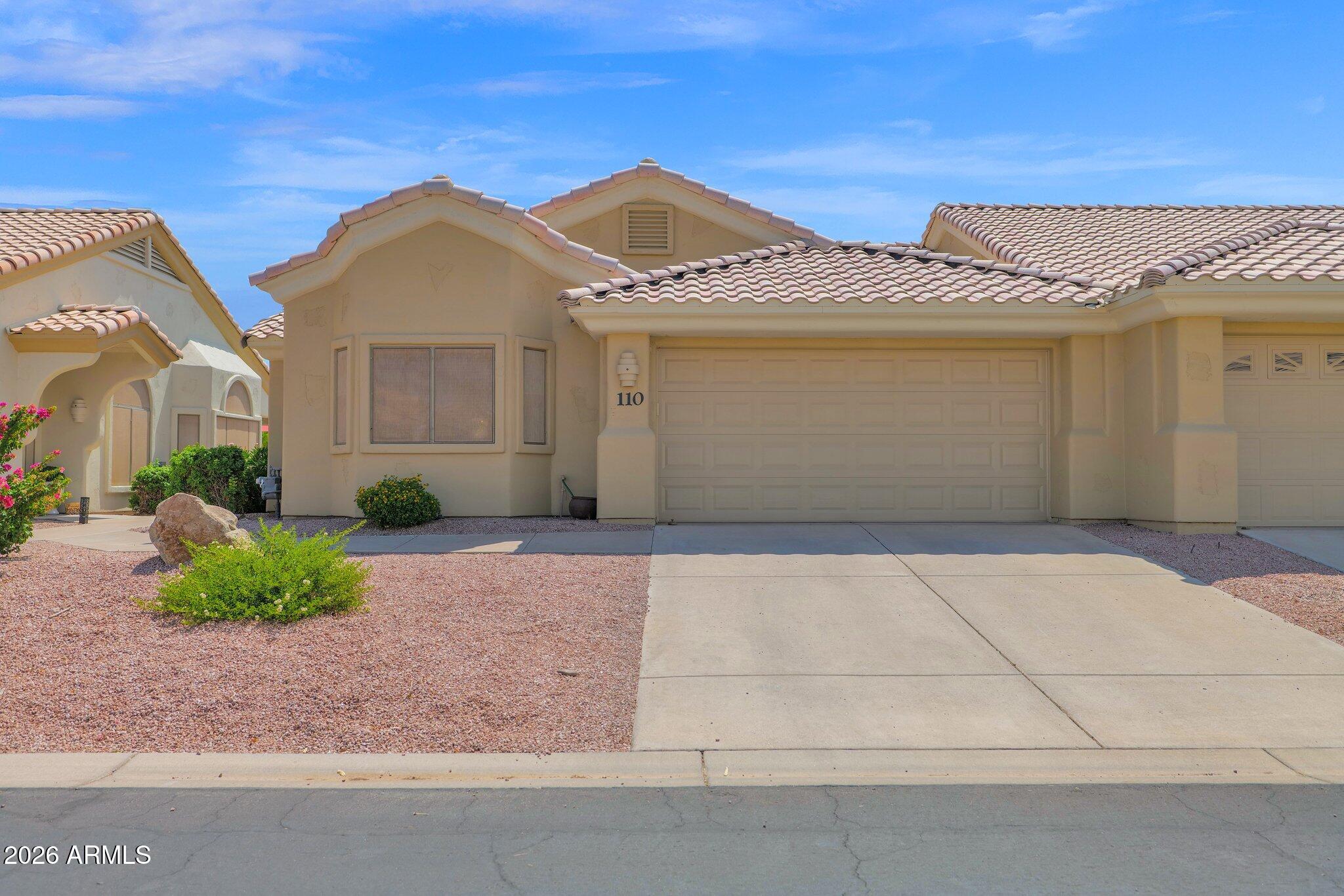 a front view of a house with a yard and garage