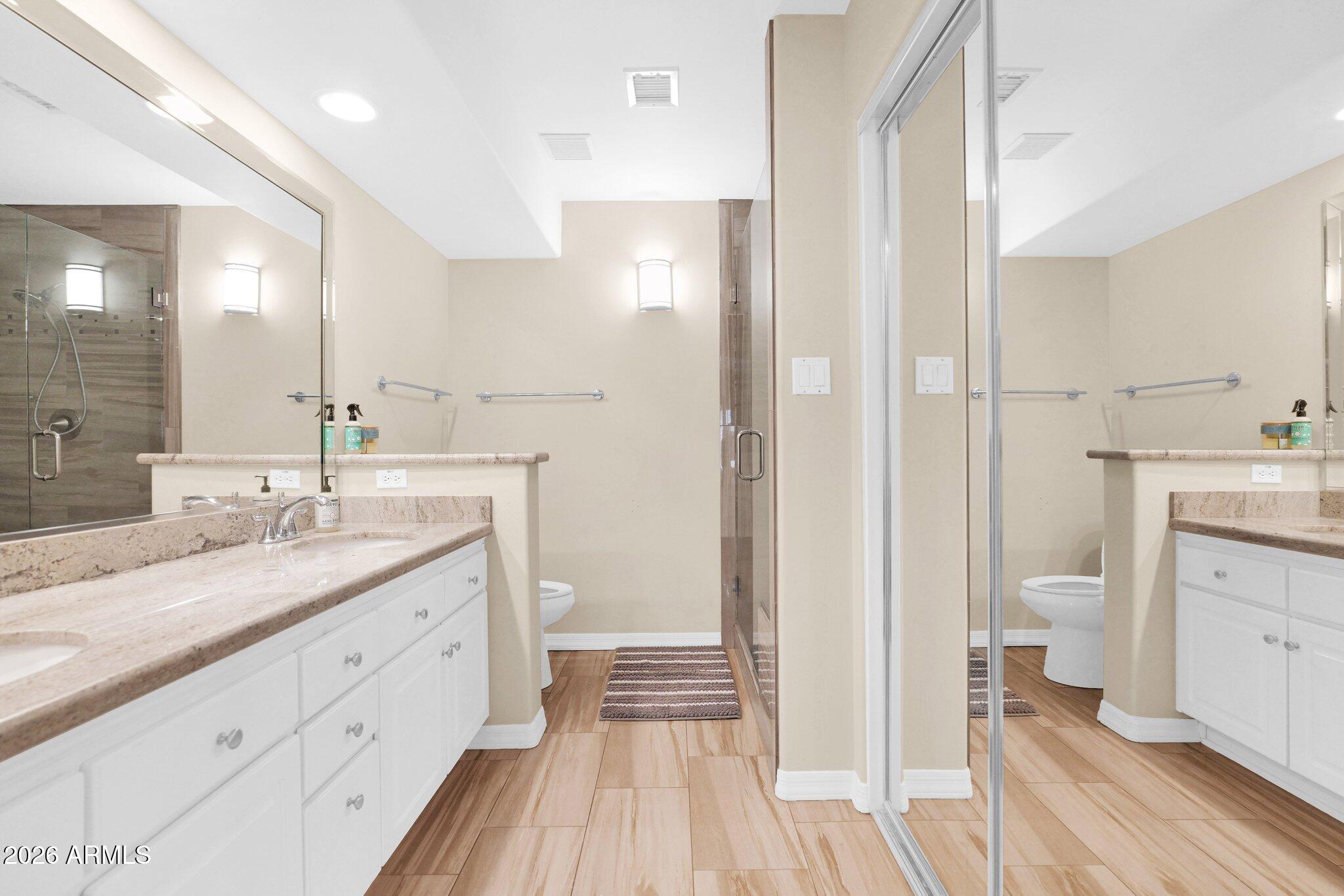 5830 East McKellips Road, Unit 110 Mesa, AZ 85215 - Photo 23 of 45 a spacious bathroom with a granite countertop sink mirror and a toilet
