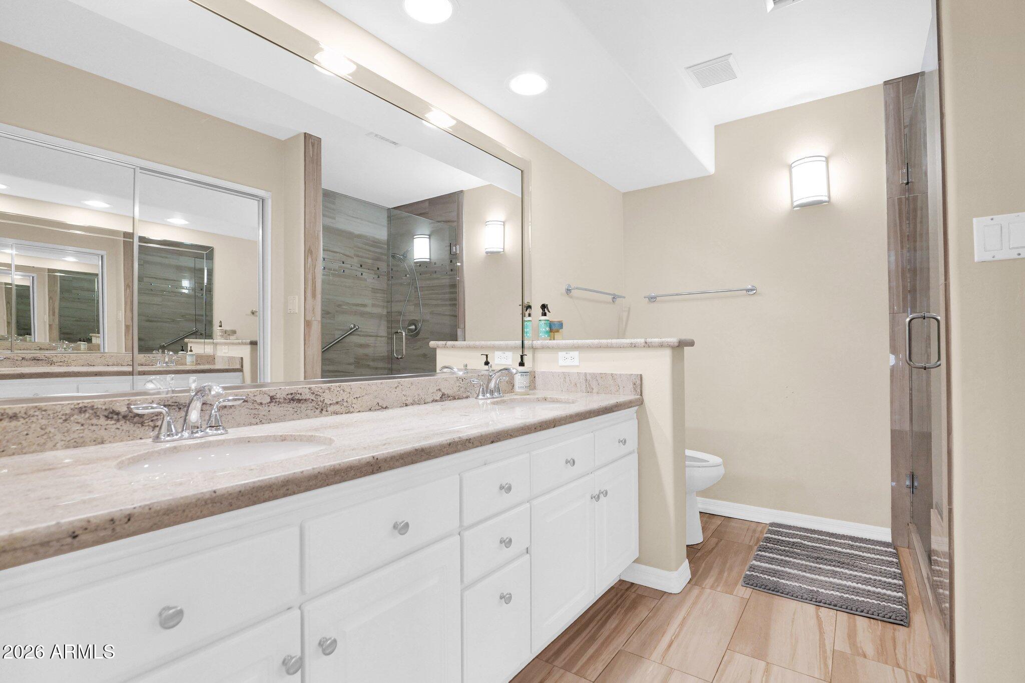 5830 East McKellips Road, Unit 110 Mesa, AZ 85215 - Photo 24 of 45 a bathroom with a double vanity sink and a mirror