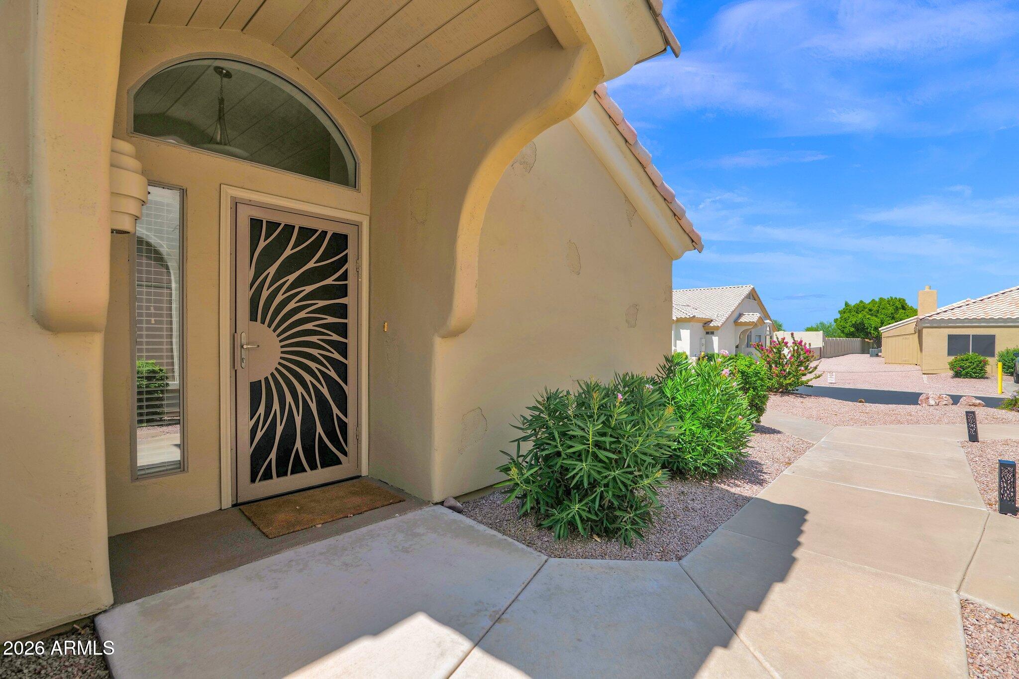 5830 East McKellips Road, Unit 110 Mesa, AZ 85215 - Photo 3 of 45 a couple of potted plants in front of door
