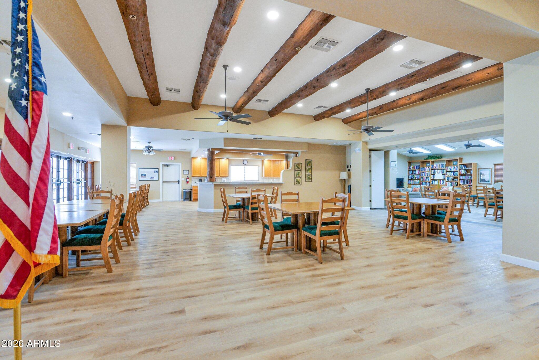 5830 East McKellips Road, Unit 110 Mesa, AZ 85215 - Photo 35 of 45 a view of a dining hall with furniture and wooden floor