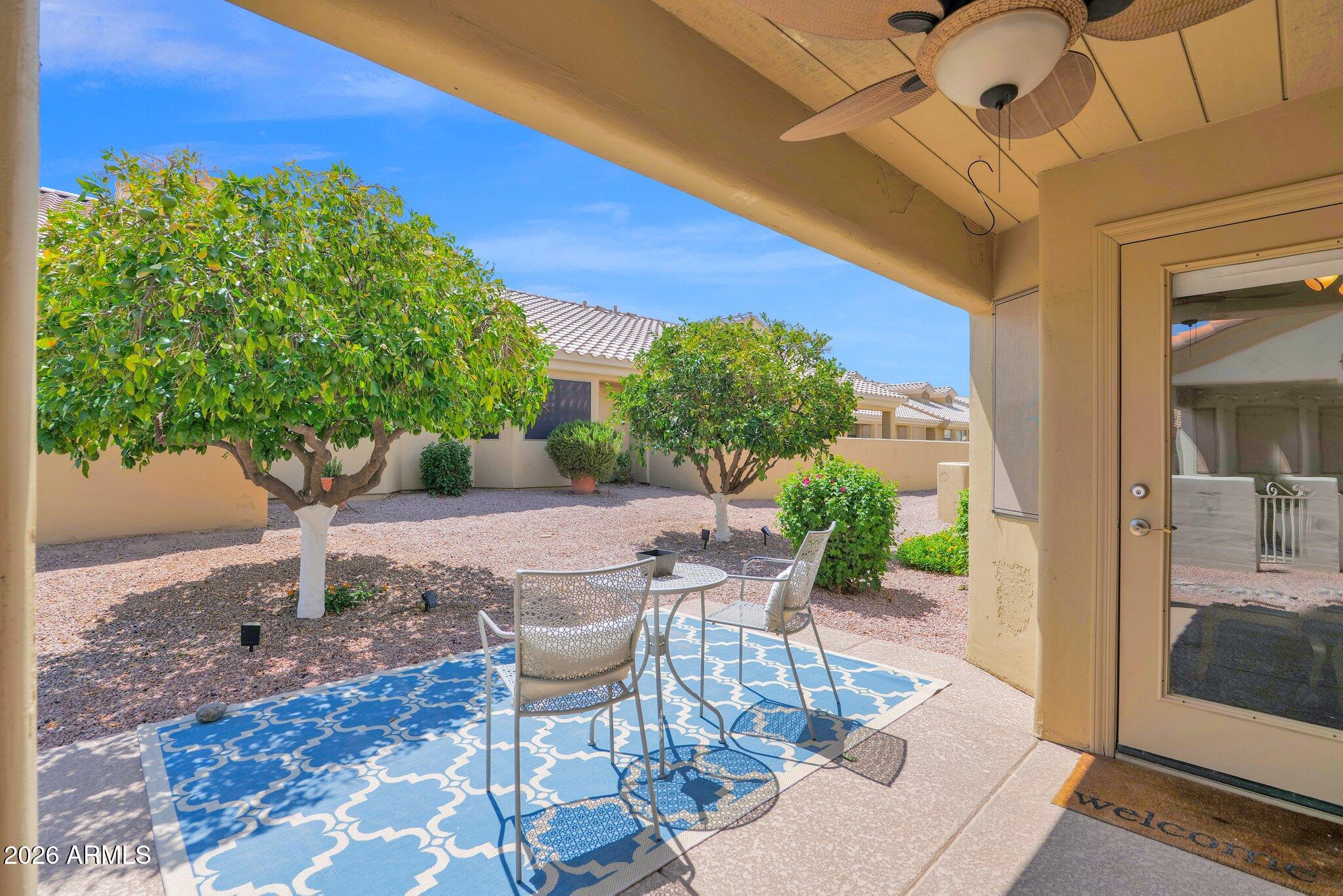 5830 East McKellips Road, Unit 110 Mesa, AZ 85215 - Photo 5 of 45 a view of a patio with table and chairs and potted plants