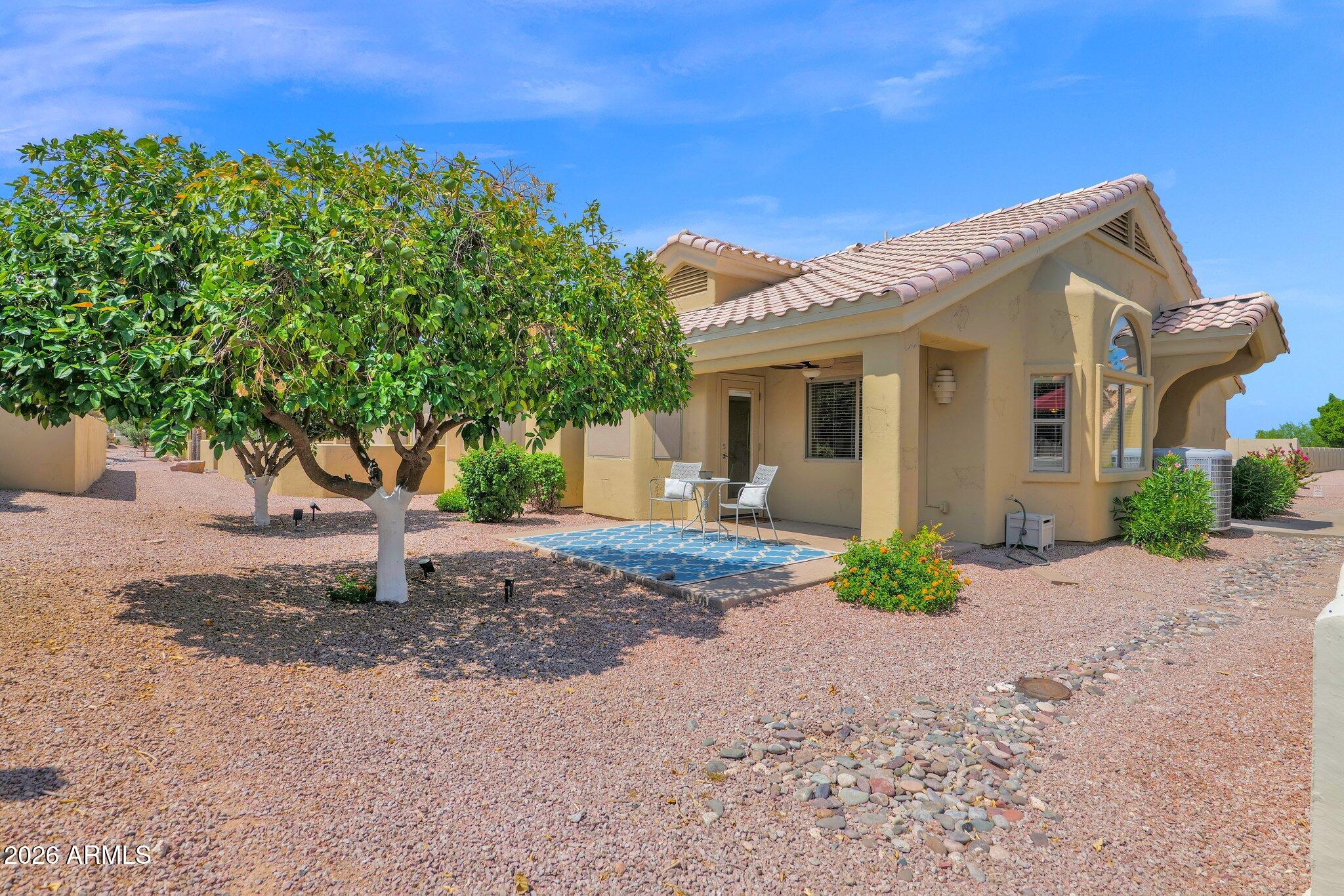 5830 East McKellips Road, Unit 110 Mesa, AZ 85215 - Photo 7 of 45 a front view of a house with a yard