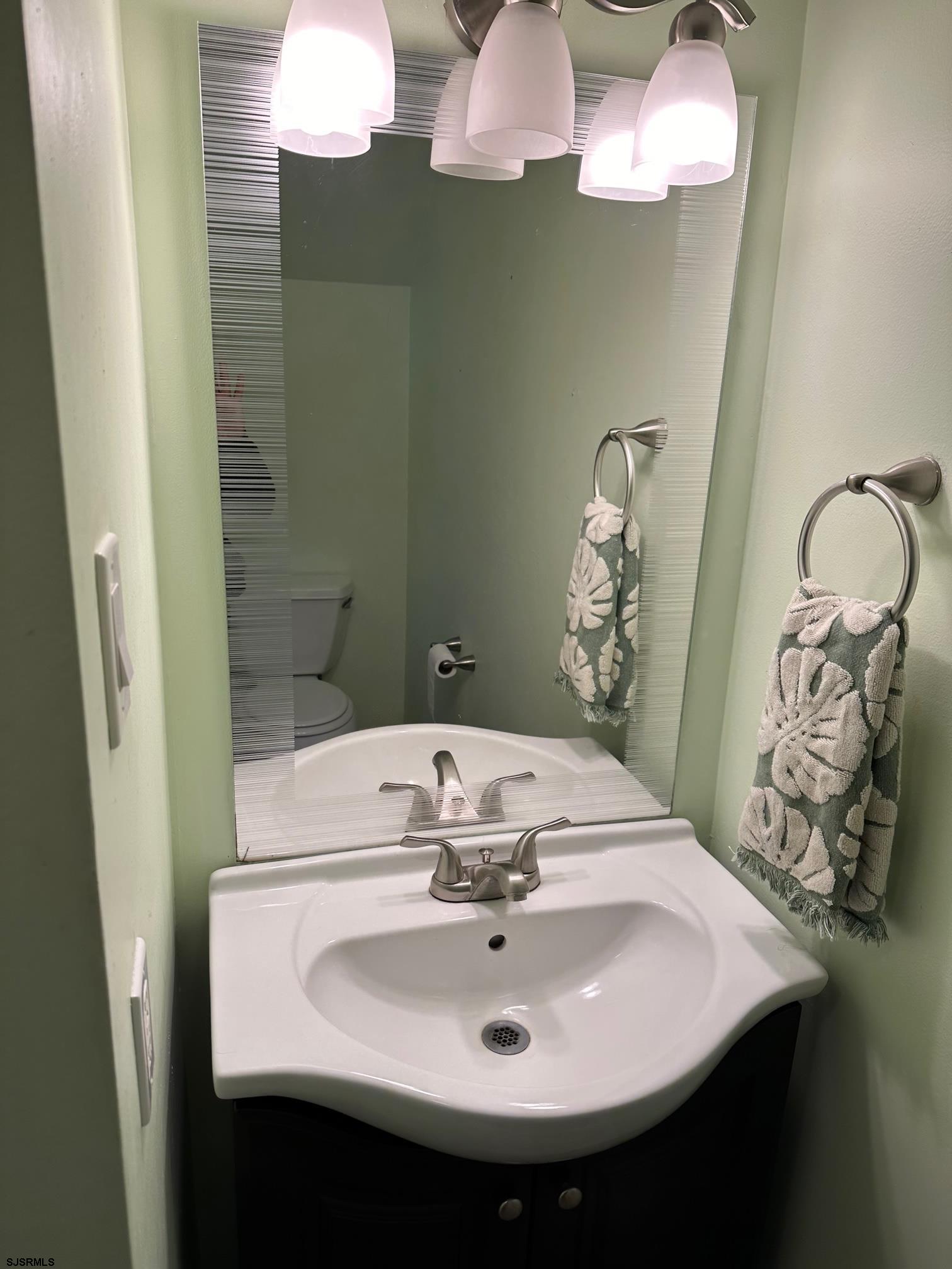 19 Cedar Court Somers Point, NJ 08244 - Photo 16 of 20 a bathroom with a sink and mirror