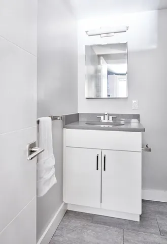 a bathroom with a sink a vanity and a mirror