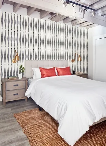 a bedroom with a bed and a night stand