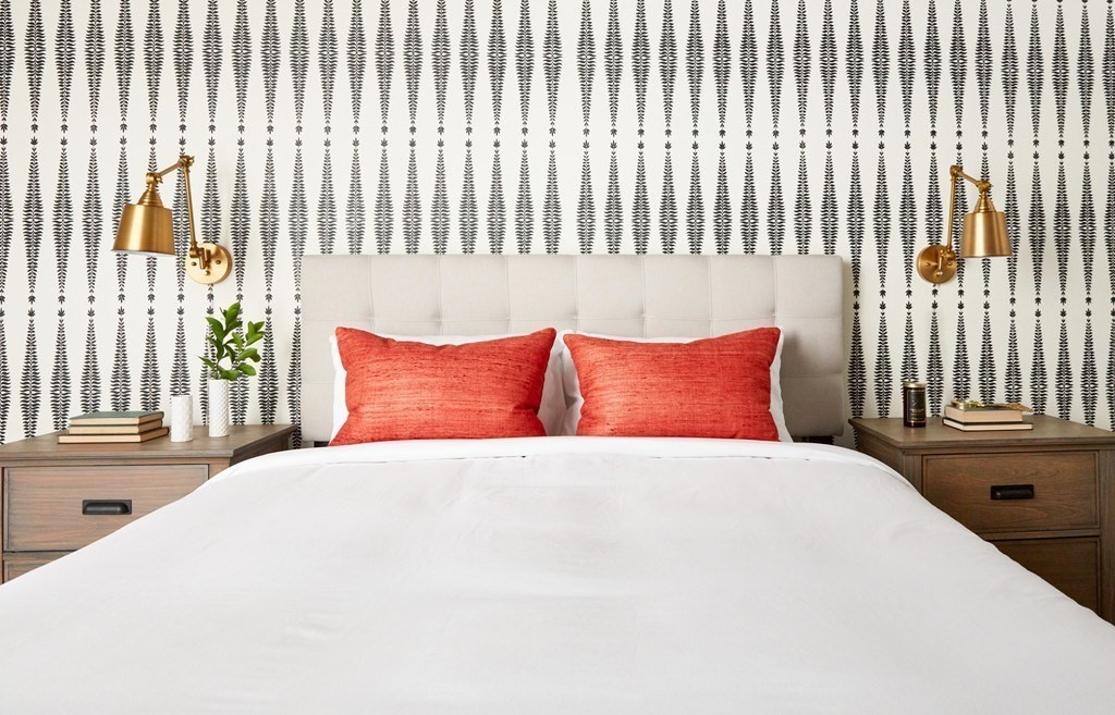 630 Washington Street, Unit 407 Boston, MA 02111 - Photo 6 of 11 a large white bed sitting in a bedroom next to a window