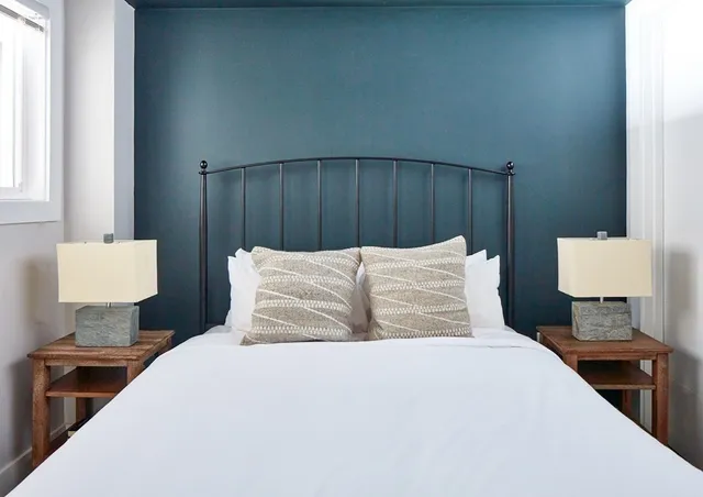 a bedroom with a bed and a lamp