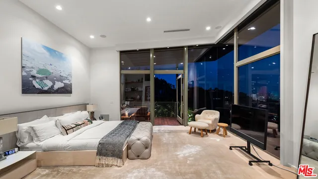 a spacious bathroom with a double vanity sink a large mirror and shower