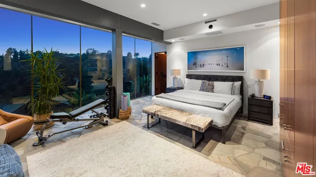 a living room with furniture potted plant and a large window