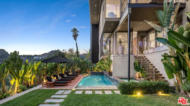 a view of yard with swimming pool and sitting area