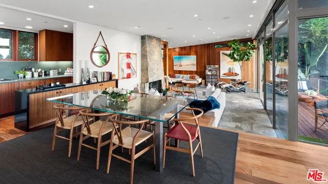 a living room with furniture floor to ceiling window and a table