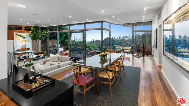 a living room with furniture and a floor to ceiling window