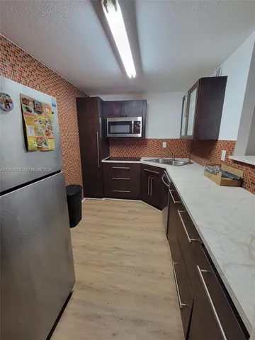 a kitchen with a stove and a refrigerator