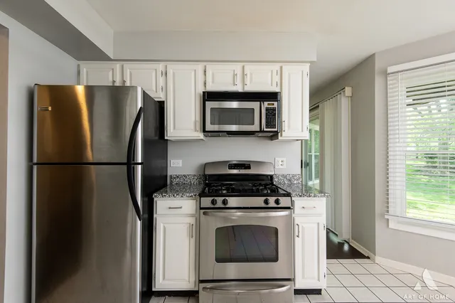 a kitchen with a refrigerator stove and microwave