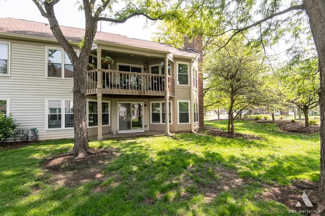 a view of a house with a yard and sitting area
