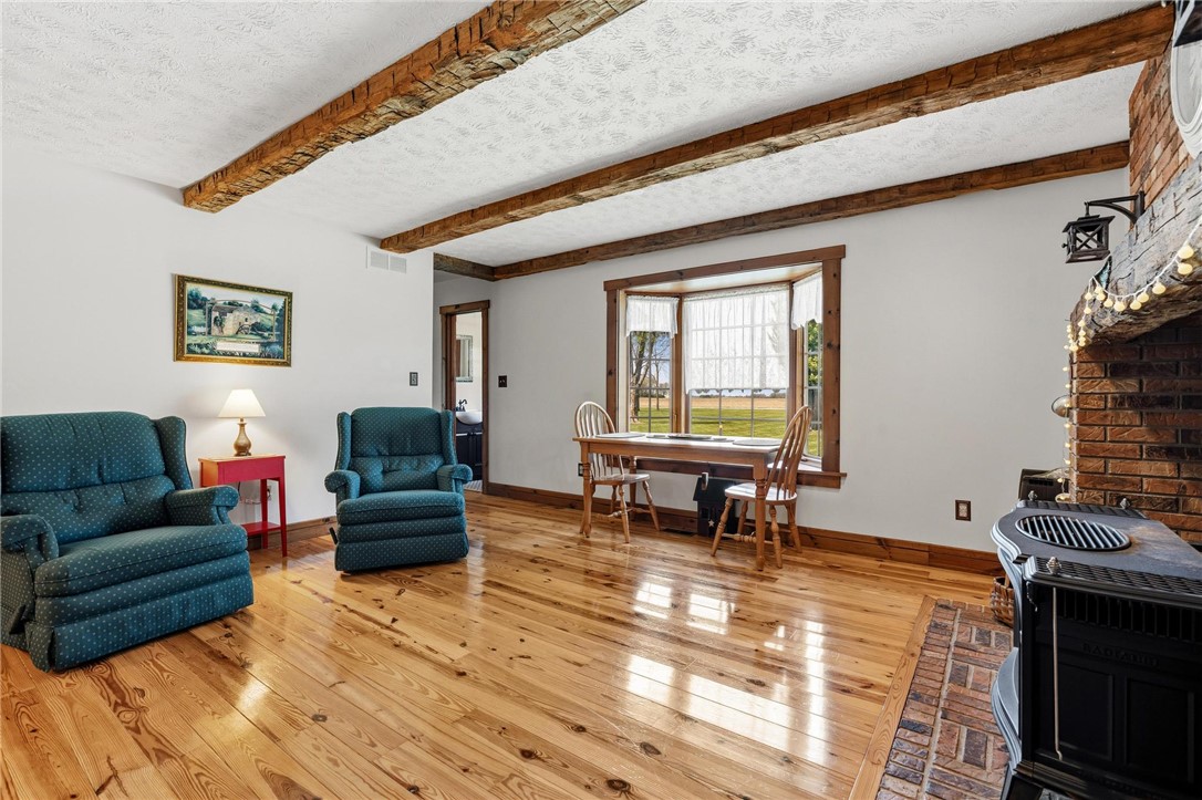 4971 Lackey Road Cedarville, OH 45314 - Photo 22 of 79 This inviting room features warm wood flooring and rustic exposed beams.