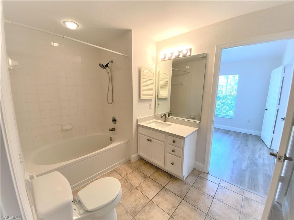7965 Preserve Circle, Unit 734 Naples, FL 34119 - Photo 13 of 20 a spacious bathroom with a double vanity sink a toilet a mirror and shower