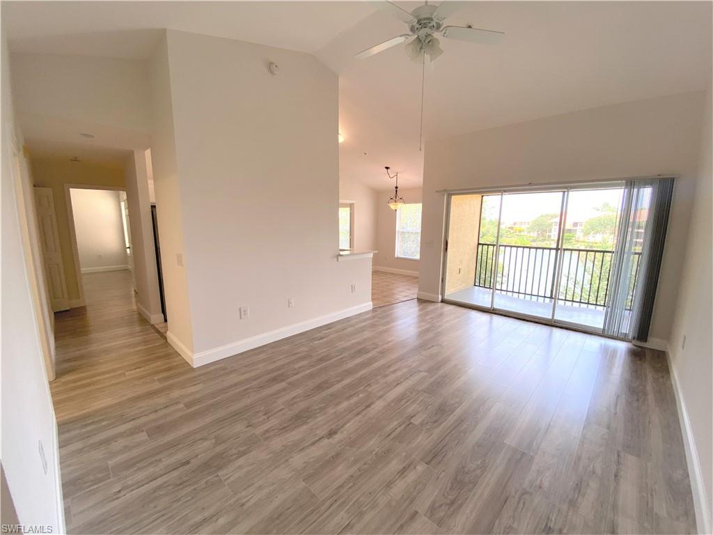 7965 Preserve Circle, Unit 734 Naples, FL 34119 - Photo 5 of 20 an empty room with wooden floor and a window