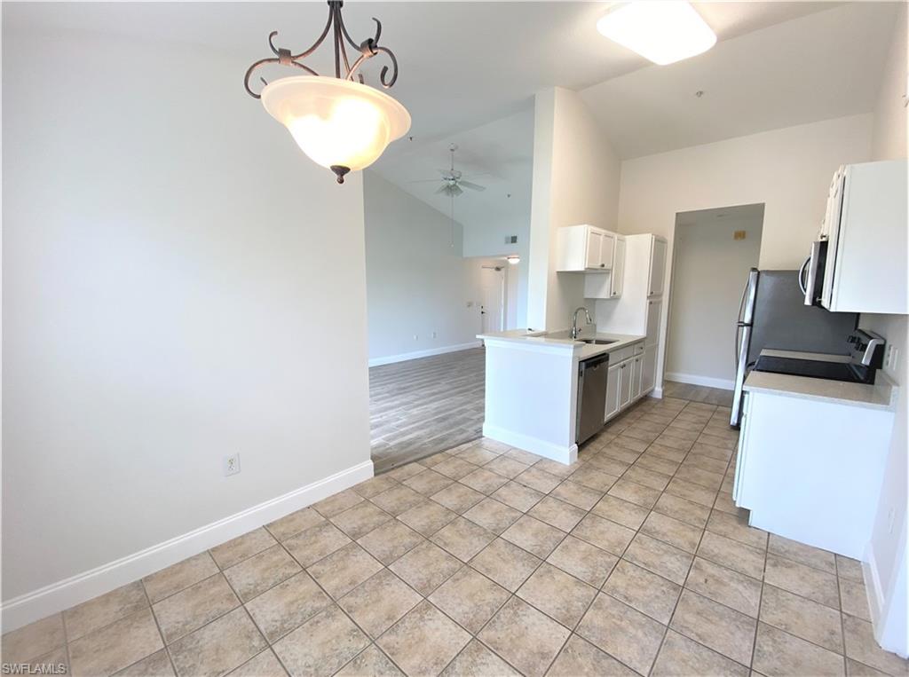 7965 Preserve Circle, Unit 734 Naples, FL 34119 - Photo 6 of 20 a kitchen with stainless steel appliances a sink stove and cabinets