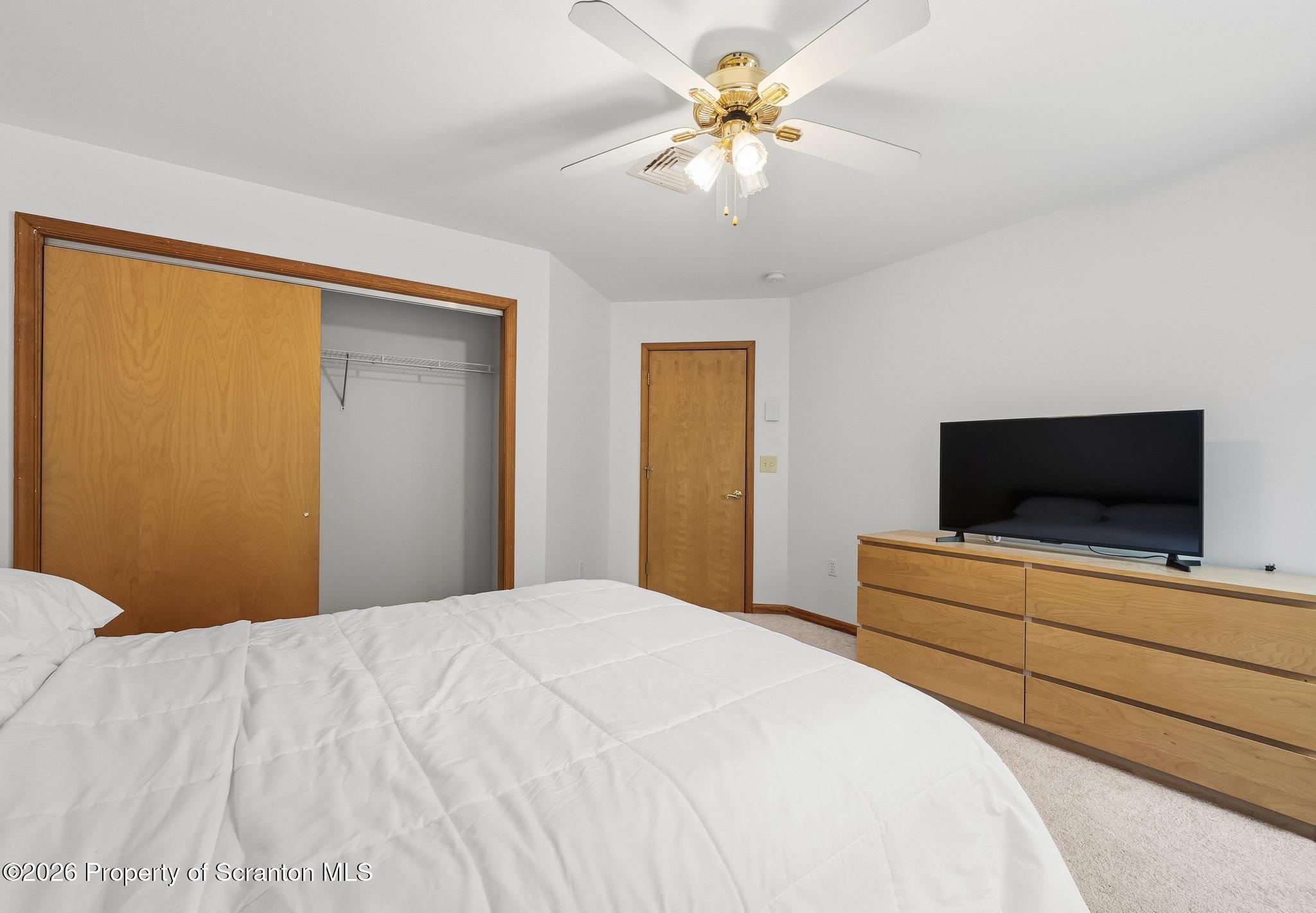 58 Bender Road Gouldsboro, PA 18424 - Photo 28 of 55 a bedroom with a bed and a flat screen tv