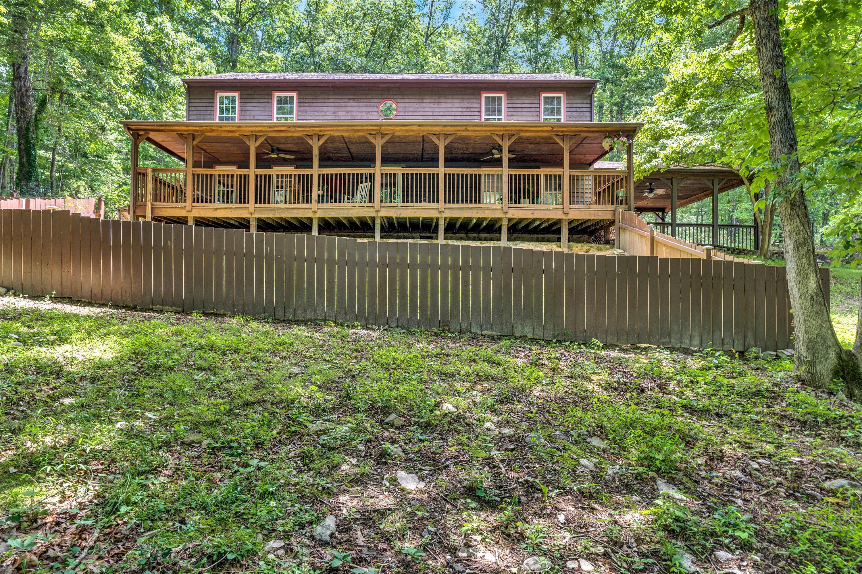 a view of a house with a wooden fence