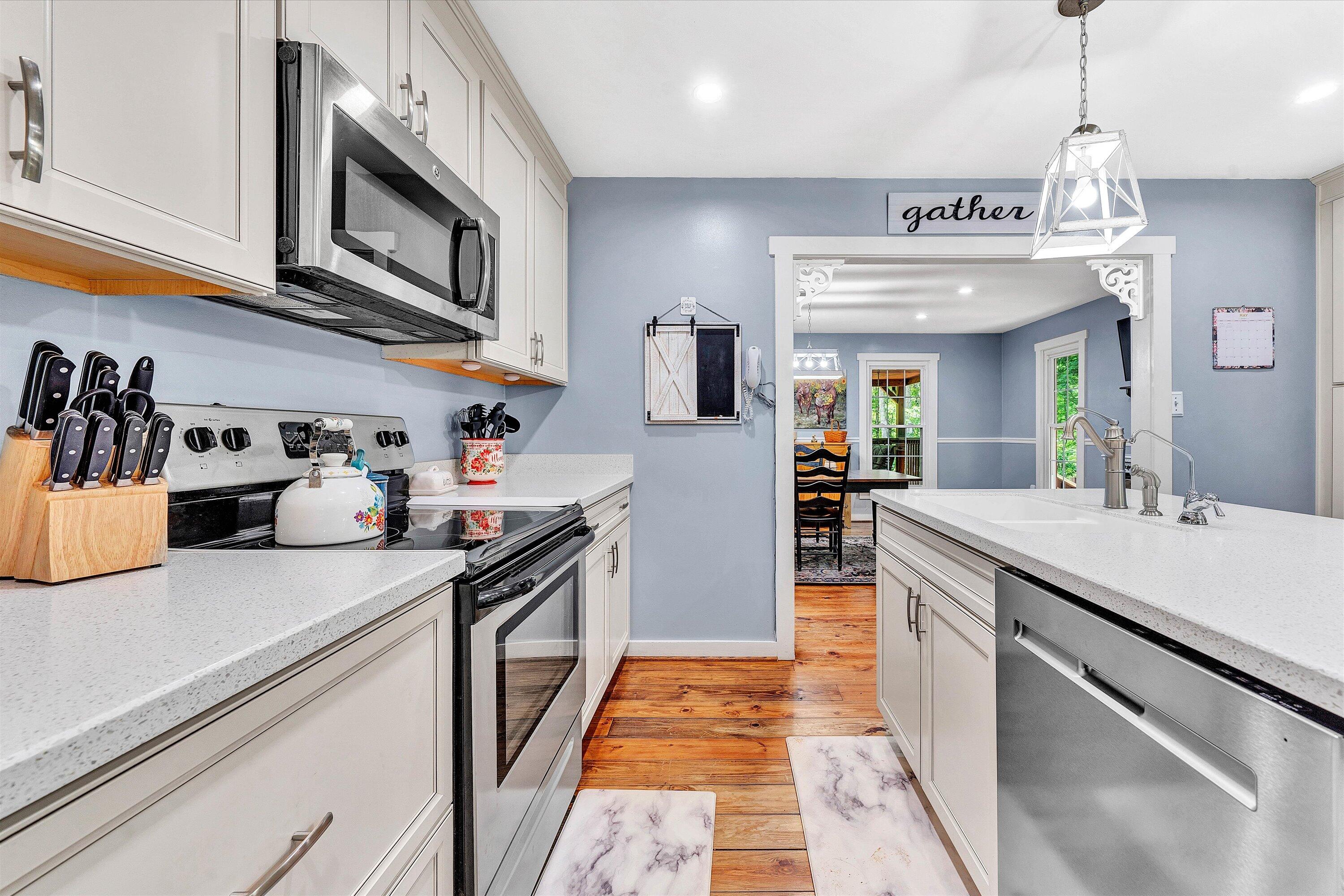 2270 Pico Road Buchanan, VA 24066 - Photo 28 of 47 a kitchen with stainless steel appliances granite countertop a sink and dishwasher a stove top oven with wooden floor