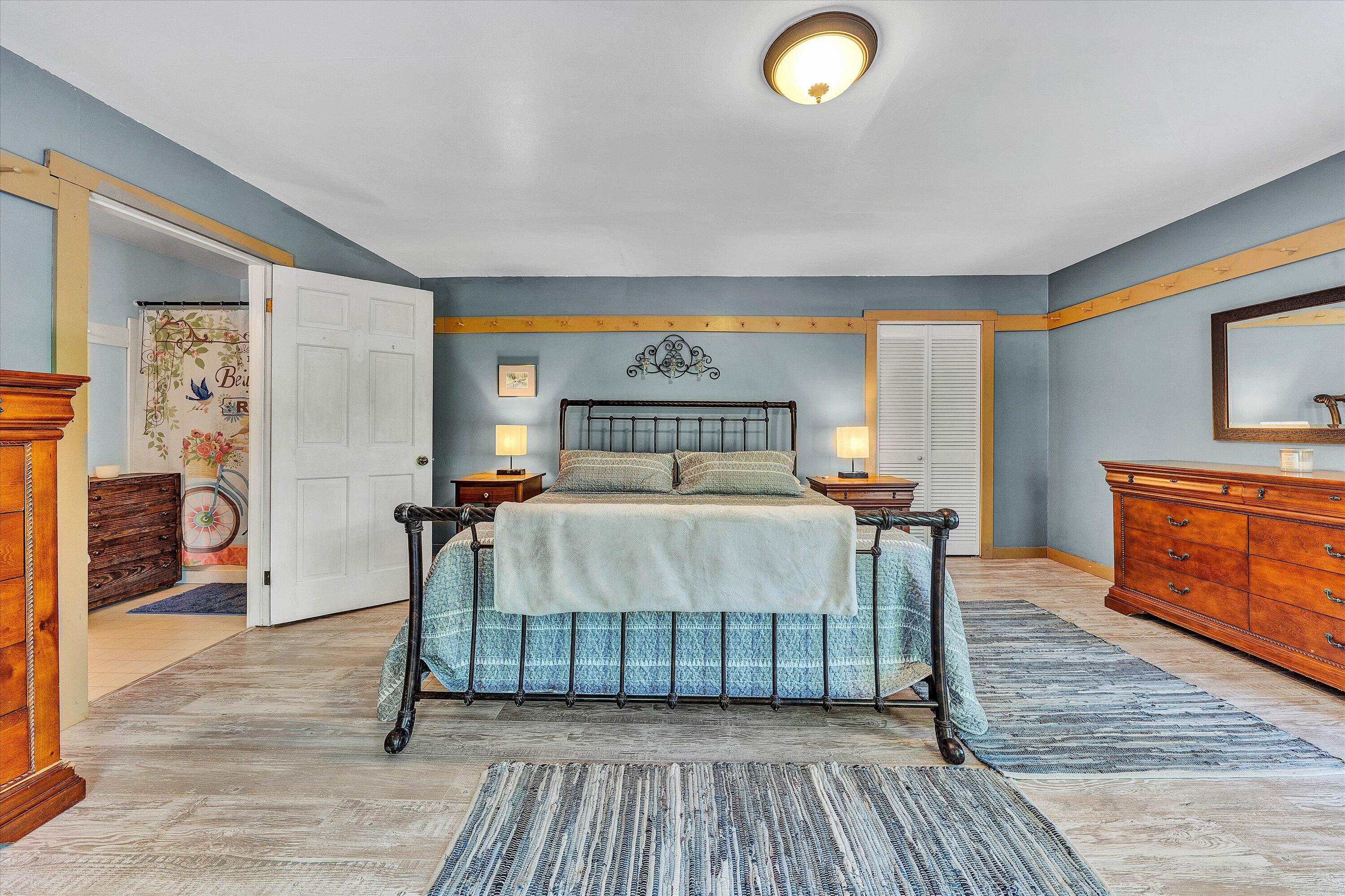 2270 Pico Road Buchanan, VA 24066 - Photo 9 of 47 a bedroom with a bed and a dresser with wooden floor