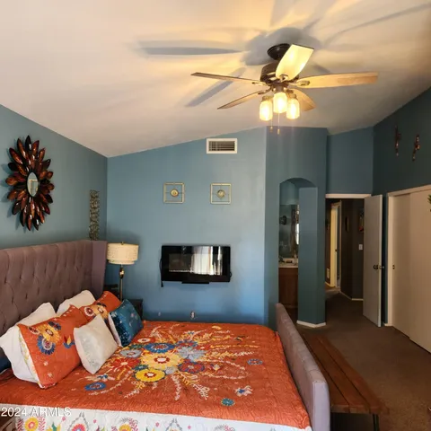 a bedroom with a bed and a chandelier