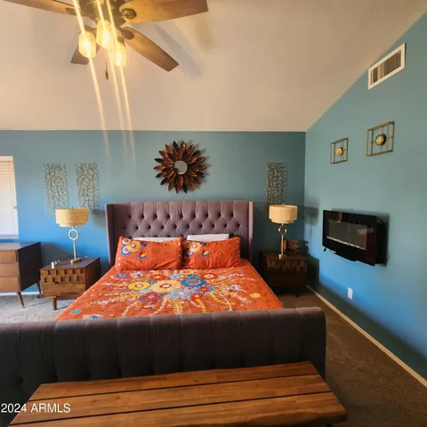 a bedroom with a bed and a potted plant