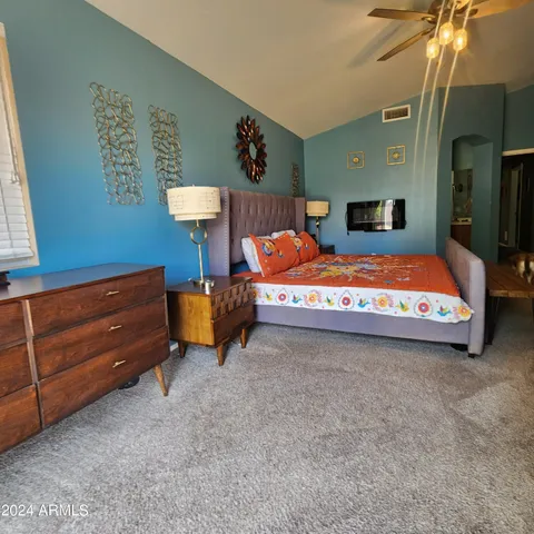 a bedroom with a bed and a chandelier