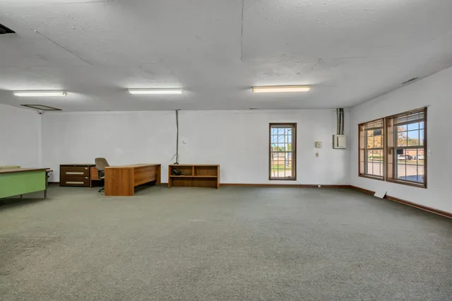 a view of a room with gym equipment and windows