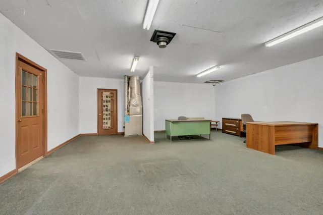 an empty room with furniture and a ceiling fan