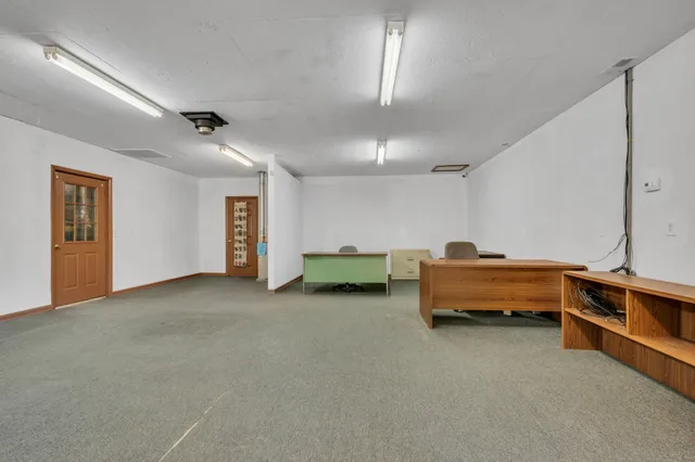 a view of a livingroom with furniture and a window